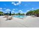 Community pool with seating and umbrellas at 3142 Dick Wilson Dr, Sarasota, FL 34240