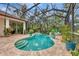 Enclosed pool and spa area with lush tropical plants at 3142 Dick Wilson Dr, Sarasota, FL 34240