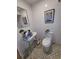 Small bathroom with pedestal sink and toilet at 3455 Anglin Dr, Sarasota, FL 34242