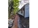 Brick pathway alongside the house and lush greenery at 3455 Anglin Dr, Sarasota, FL 34242