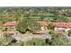 Aerial view of condos with red tile roofs and verdant grounds near a pond and golf course at 3500 El Conquistador Pkwy # 119, Bradenton, FL 34210