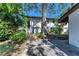 Exterior view of a white multi-Gathering building with lush landscaping and a brick path at 3500 El Conquistador Pkwy # 119, Bradenton, FL 34210