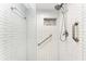 Walk-in shower with subway tile and grab bar at 3500 El Conquistador Pkwy # 119, Bradenton, FL 34210