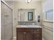 Bathroom with granite countertop and walk-in shower at 3762 San Luis Dr, Sarasota, FL 34235