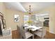 Elegant dining room, staged with table and chairs, hardwood floors at 3762 San Luis Dr, Sarasota, FL 34235