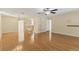 Open living and dining area with hardwood floors and a built-in bookcase at 3762 San Luis Dr, Sarasota, FL 34235