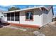 Exterior view of single story home with screened porch and landscaping at 3815 42Nd W Ave, Bradenton, FL 34205