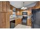 Cozy kitchen with dark wood cabinets, black appliances, and a granite countertop at 3815 42Nd W Ave, Bradenton, FL 34205