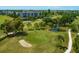 Aerial view of the golf course with ponds, sand traps, and manicured greens in a community at 3880 Ironwood Ln # 408E, Bradenton, FL 34209