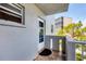 Exterior view of balcony with white door, gray trim, and tile flooring at 3880 Ironwood Ln # 408E, Bradenton, FL 34209