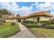 Inviting building exterior with manicured landscaping and a brick walkway to the entrance at 3880 Ironwood Ln # 408E, Bradenton, FL 34209