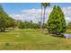 Beautiful golf course view with flags, mature trees, and water features under a sunny sky at 3880 Ironwood Ln # 408E, Bradenton, FL 34209