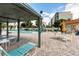 Inviting poolside seating area with a shaded pergola, comfortable lounge chairs, and umbrella-covered tables at 3880 Ironwood Ln # 408E, Bradenton, FL 34209