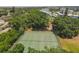 Aerial shot of well-maintained tennis courts nestled among mature trees and lush greenery at 3880 Ironwood Ln # 408E, Bradenton, FL 34209