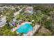 Aerial view of community pool with palm trees and a poolside cabana at 3911 Douglas Hill Pl, Parrish, FL 34219