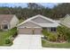 Two-story house with a three-car garage and landscaped yard at 3911 Douglas Hill Pl, Parrish, FL 34219