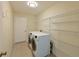 Laundry room with washer, dryer, and ample shelving at 3911 Douglas Hill Pl, Parrish, FL 34219