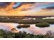 Stunning sunset over calm waters and mangroves at 393 N Point Rd # 604, Osprey, FL 34229