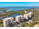 Drone view of multiple condo buildings overlooking the bay at 393 N Point Rd # 604, Osprey, FL 34229