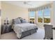 Charming bedroom with a queen bed and lovely window views at 393 N Point Rd # 604, Osprey, FL 34229