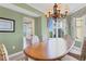 Light-filled dining room with wood table and view to kitchen at 393 N Point Rd # 604, Osprey, FL 34229