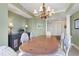 Spacious dining area with a large wood table and chandelier at 393 N Point Rd # 604, Osprey, FL 34229