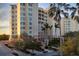 Elegant condo building with palm trees and landscaping at 393 N Point Rd # 604, Osprey, FL 34229