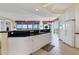 Kitchen boasts white cabinets, granite countertops and stainless steel appliances at 393 N Point Rd # 604, Osprey, FL 34229