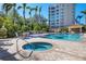 Resort-style pool and spa with comfortable lounge chairs and patio area at 393 N Point Rd # 604, Osprey, FL 34229