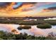 Scenic sunset view over calm water and mangrove islands at 393 N Point Rd # 604, Osprey, FL 34229