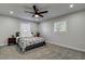 Bedroom with floral bedding and ceiling fan at 3950 Sawyerwood Rd, Sarasota, FL 34233