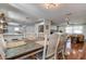 Bright dining area with farmhouse table and view into the living room and kitchen at 3950 Sawyerwood Rd, Sarasota, FL 34233