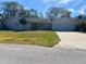 Newly painted single-story house with a driveway and lush lawn at 3950 Sawyerwood Rd, Sarasota, FL 34233