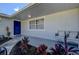 Front entrance with blue door, tile flooring, and comfortable seating at 3950 Sawyerwood Rd, Sarasota, FL 34233