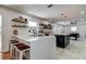 Modern kitchen with white quartz countertops and wooden shelving at 3950 Sawyerwood Rd, Sarasota, FL 34233