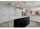 Modern kitchen with white cabinets, quartz countertops, and a large island at 3950 Sawyerwood Rd, Sarasota, FL 34233