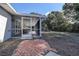 View of the screened porch and backyard from outside at 3950 Sawyerwood Rd, Sarasota, FL 34233