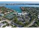 Aerial view of waterfront community with tennis courts, marina, and lush landscaping at 419 Partridge Cir, Sarasota, FL 34236