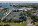 Aerial view of tennis courts, marina, and surrounding waterfront homes at 419 Partridge Cir, Sarasota, FL 34236