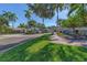 Gated community entrance with lush landscaping and brick pavers at 419 Partridge Cir, Sarasota, FL 34236