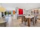 Modern dining room with white table and wood chairs, and red wall art at 419 Partridge Cir, Sarasota, FL 34236