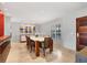 Modern dining room with a white table and wood chairs near a hardwood floor at 419 Partridge Cir, Sarasota, FL 34236