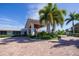 Main entrance to clubhouse with palm trees and brick driveway at 419 Partridge Cir, Sarasota, FL 34236