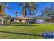 House with a tile roof, mature landscaping, and a two-car garage at 419 Partridge Cir, Sarasota, FL 34236