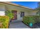 Well-maintained front entrance with a modern wooden door and landscaping at 419 Partridge Cir, Sarasota, FL 34236