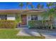 Inviting front entrance with a wood door and neatly trimmed hedges at 419 Partridge Cir, Sarasota, FL 34236