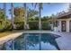 Relaxing pool area with palm trees and a spacious patio at 419 Partridge Cir, Sarasota, FL 34236