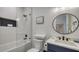 Modern bathroom with white tile, soaking tub, and a frameless glass shower at 421 Pine Ave, Anna Maria, FL 34216