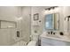 Clean bathroom with a glass shower, white vanity, and modern fixtures at 421 Pine Ave, Anna Maria, FL 34216