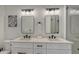 Double vanity bathroom with modern lighting and white cabinets at 421 Pine Ave, Anna Maria, FL 34216